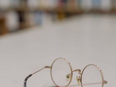 Glass of water on a white table near a book